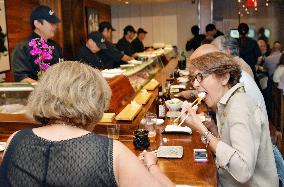 New Yorkers enjoy sushi at high-end restaurant