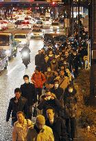 CORRECTED People in Tokyo walk home after March 2011 disaster