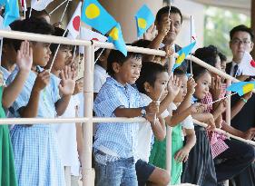 Palauans welcome imperial couple, wave Japanese flags