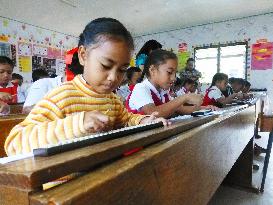 School children learning abacus in Tonga