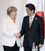 Japan's Abe, Germany's Merkel meet in Turkey