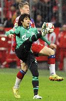Japan defender Uchida of Schalke tussels for ball with Munich player