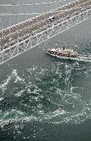 Ship sails by big whirlpool in Naruto Strait, western Japan