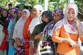 Evacuated Filipino women line up for rations