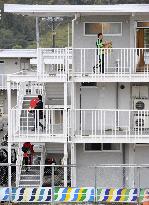 People moving into three-story temporary housing complex