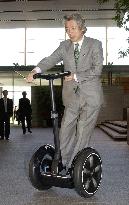 Koizumi rides 'Segway' scooter to office