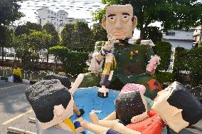 Papier-mache figures squib Thai military regime in Bangkok