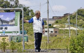Man stands on platform of JR Senseki Line's former station