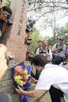 Japanese war orphans visit grave of Chinese foster parents