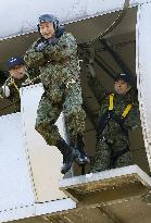 Japan's Defense Minister Nakatani inspects parachute drill