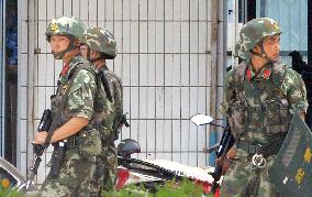 Armed police officers patrol in China's Xinjiang Uyghur region