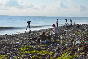 Press members work at Reunion Island beach