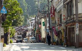 Street almost empty at foot of erupting Mt. Ontake