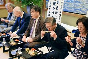 Participants try ancient "kamaboko" fish cakes in Kyoto