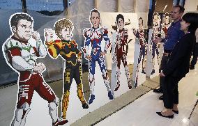 Cardboard cutouts of G-7 leaders as superheroes