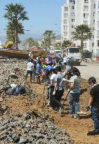 Volunteers clean up tsunami debris in Chile