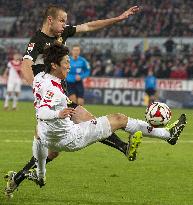 Japan forward Osako of Koln competes for ball in game vs. Stuttgart