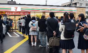 People queue for Seven-Eleven store opening in western Japan