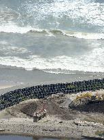 Sandbags piled up around water gate hit by 2011 tsunami