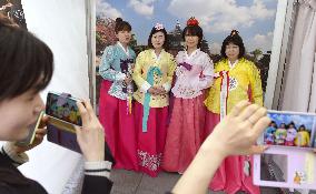 Young women clad in traditional costumes at live Korean pop event