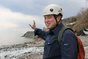 Expert examines raised coastline portion on northern Japan peninsula