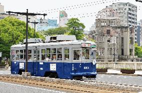 Hiroshima tram in 1945 colors runs near A-bomb dome