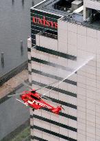 Firefighting helicopter debuts in drill on skyscraper