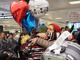 Iranian sisters hug at airport following court decision