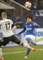 Japanese defender Uchida of Schalke makes pass in Bundesliga match