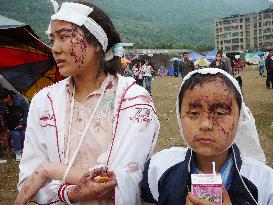 China earthquake -- children with blood stains on their faces