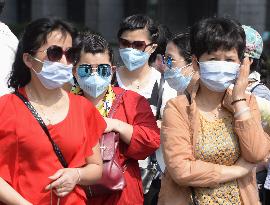 Pedestrians wear masks in central Seoul