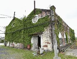 Old pump house of Yawata Steel Works covered with ivy