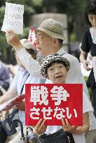 Japan's ruling camp rams security bills through lower house