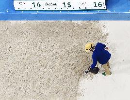 Olympic scenes: Watering sand before women's triple jump