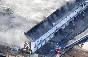 Fire continues to burn Japanese firm's distribution center