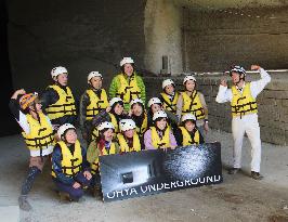 Participants pose before raft tour at quarry site in eastern Japan