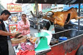 Spit-roasted cow served on Phnom Penh street