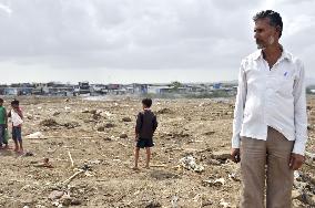 Indian NGO worker stands in suburban Mumbai slum