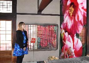 Photographer visits hot spring decorated with her works