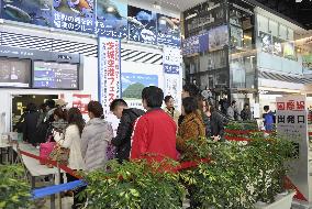 Passengers wait at east Japan airport to board Shanghai-bound plane