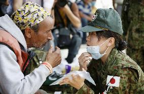 Japanese SDF medical team examines patient in quake-struck Nepal