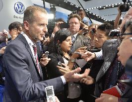 VW executive surrounded by reporters at Tokyo Motor Show
