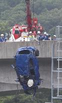 2 killed after car falls off highway and jumps over train tracks