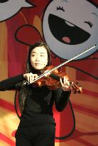 Japanese viola player plays at Olympic Village in Turin