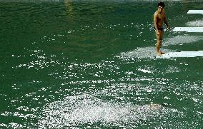 Olympic scenes: Practicing in green diving pool