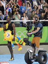 Olympic scenes: Bolt followed by Segway-like vehicle