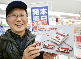 Nintendo launches palm-sized Famicom game console amid fanfare