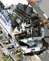 Car crashes into tourist bus, killing 1, injuring 45