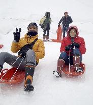 Tourists enjoy sled-riding in central Japan