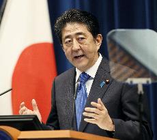 Abe announces sales tax hike delay to October 2019